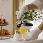 Papacko paper cups for hotels displayed on room service tray with coffee and breakfast at luxury hospitality venue