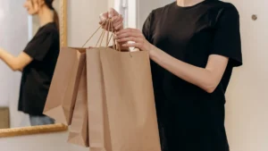Papacko kraft paper bags for retail takeaway showing various handle types and printed branding options