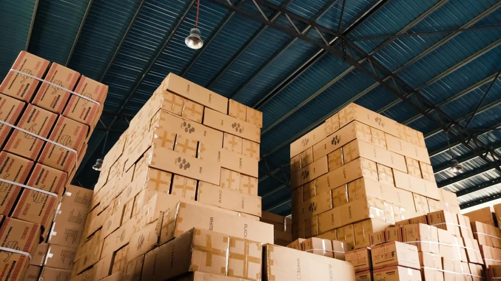 Wholesale paper cups bulk inventory stacked on pallets in distribution warehouse - Papacko