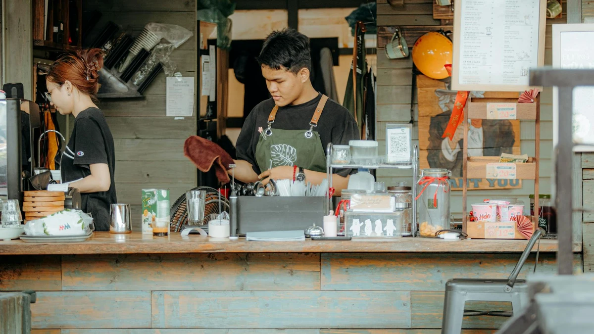 Papacko coffee shop barista preparing hot beverages with ripple wall cups on counter