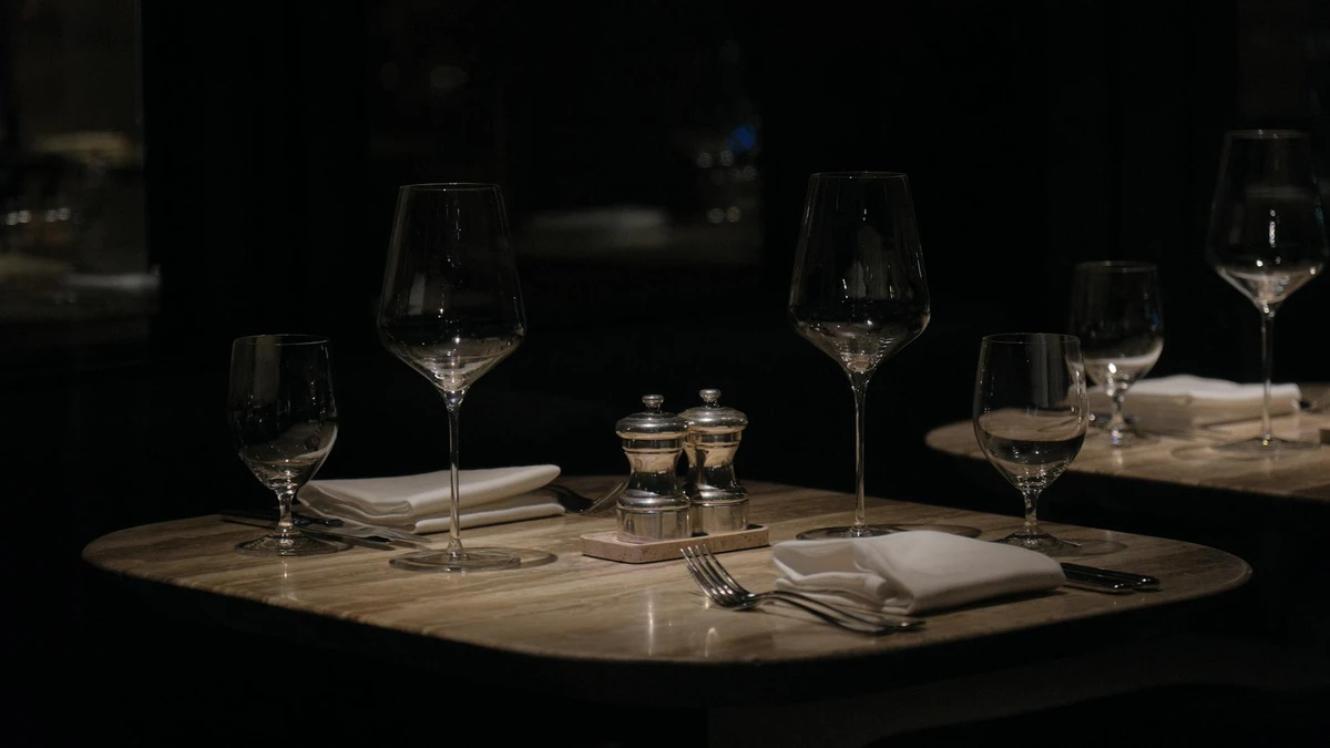 Papacko upscale restaurant interior with elegantly set tables featuring white napkins and fine dining atmosp