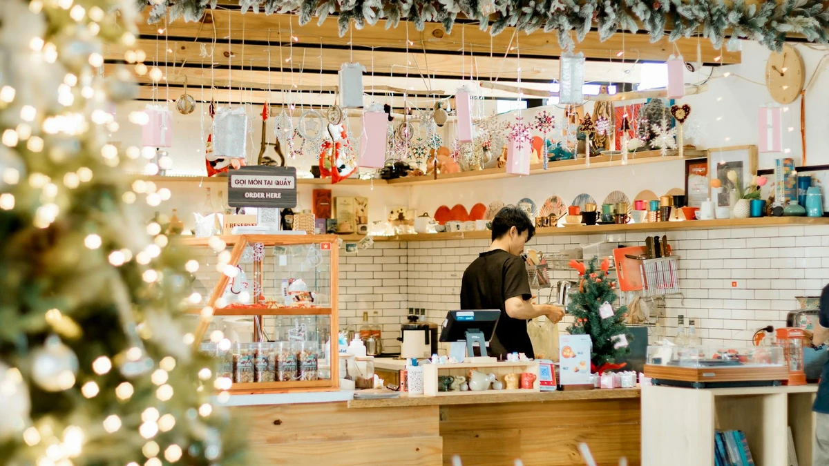 Papacko coffee shop counter displaying various seasonal cup sleeves with holiday decorations and festive des