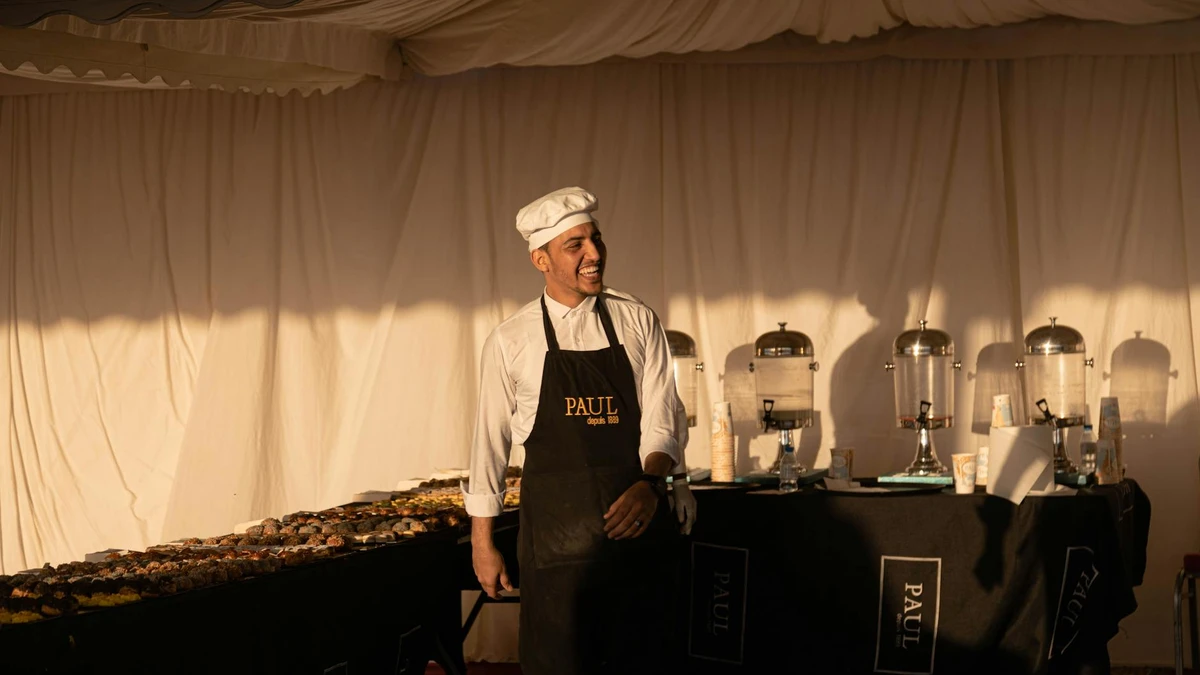 Papacko catering staff preparing food in eco-friendly compostable containers at outdoor event