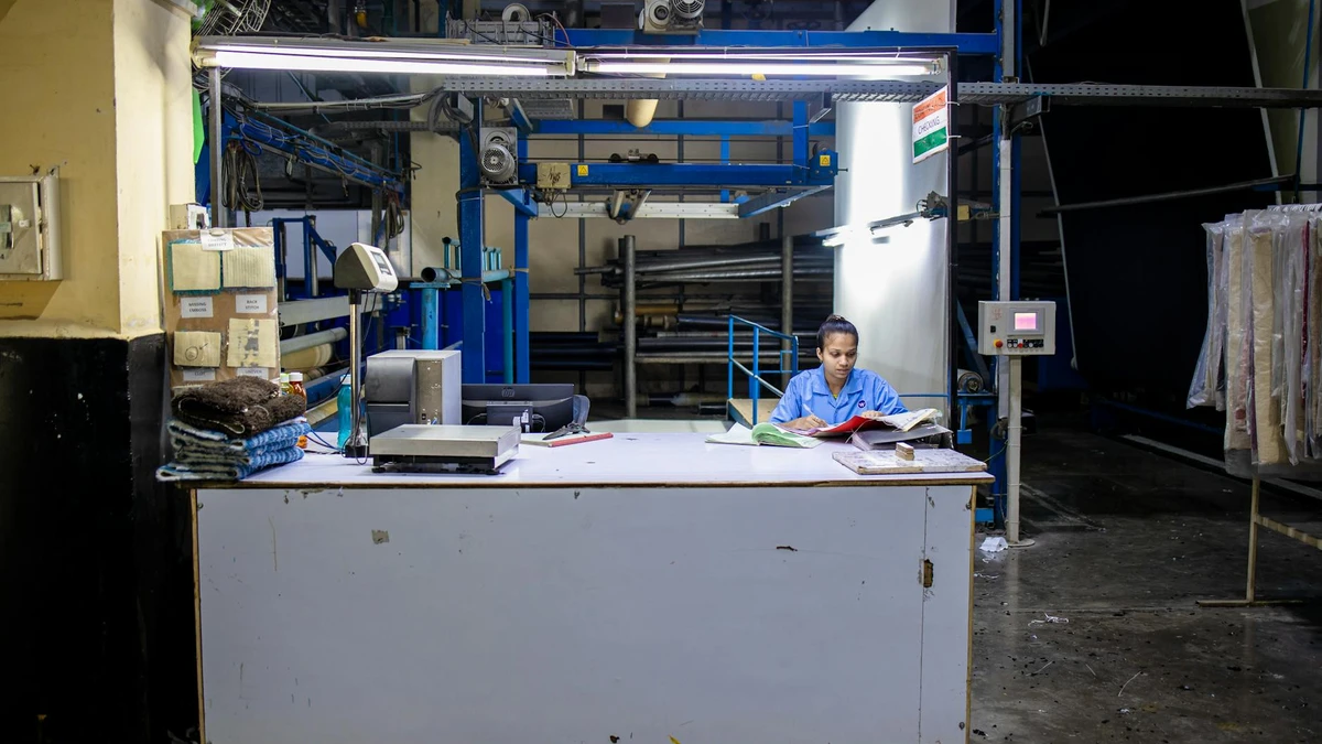 Papacko quality control inspector examining paper cups with certification documents and testing equipment