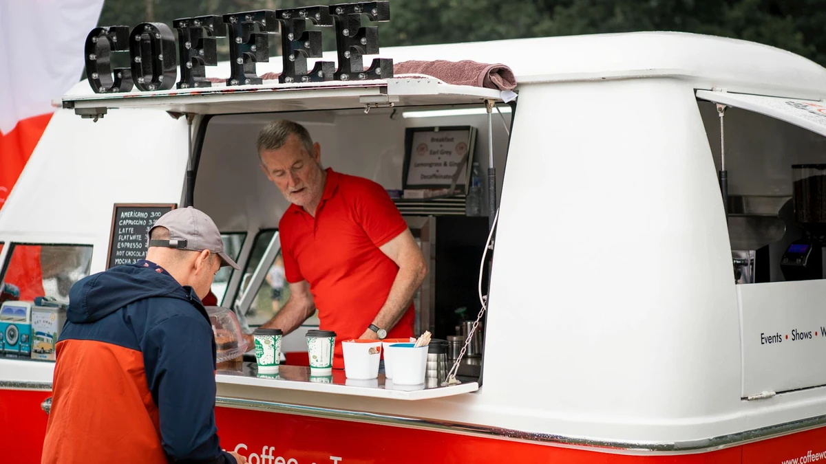 Papacko outdoor event vendor serving drinks in sustainable paper cups with recycling signage