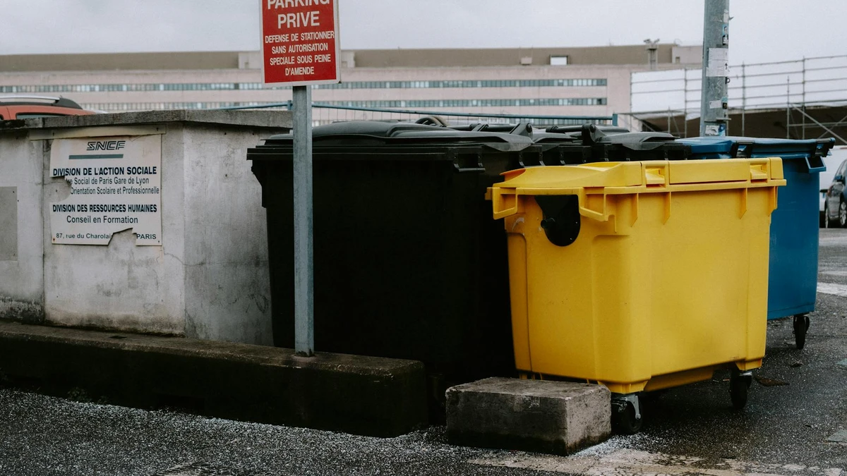 Event staff managing compostable waste stream for sustainable festival - Papacko environmental event planning