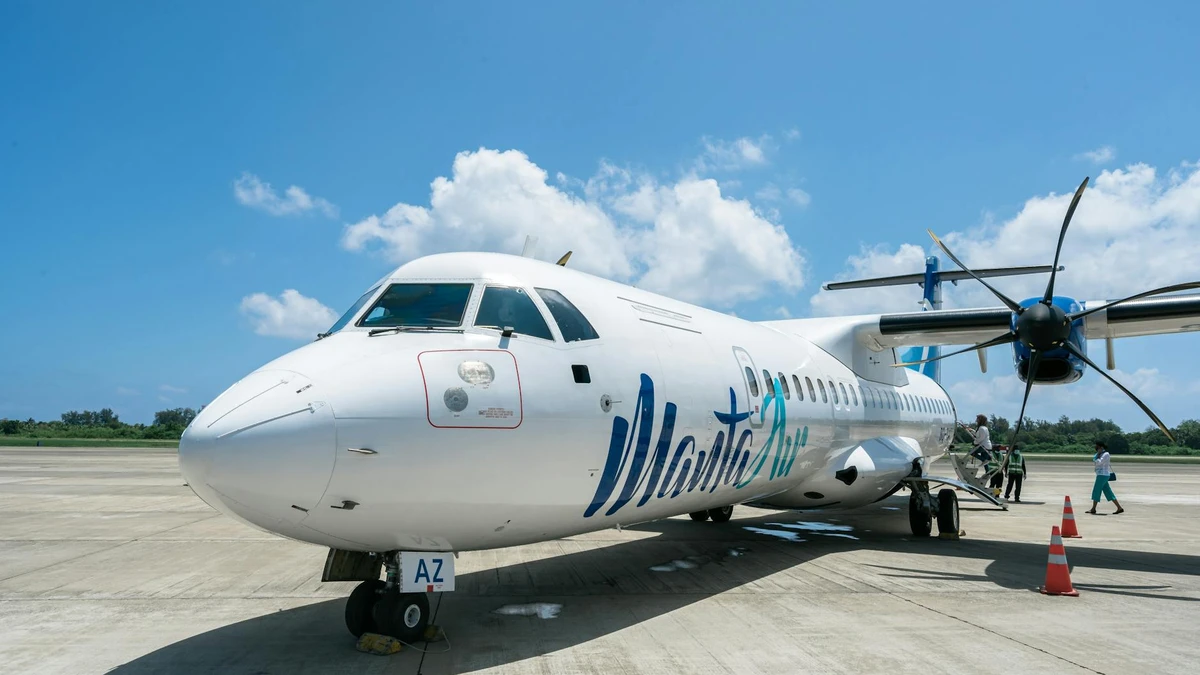 Papacko Flight attendant loading meal containers into convection oven in airplane galley