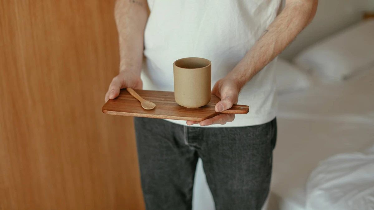 Papacko hands holding minimalist coffee bag showing tactile texture and simple elegant branding details