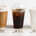 Three disposable coffee cup materials — paper, plastic, and PLA — displayed side by side for comparison.