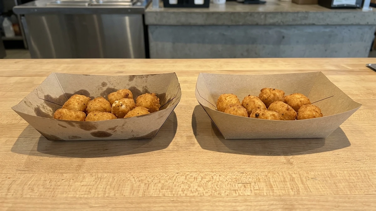 Side-by-side comparison of uncoated and PE-coated paperboard snack trays holding fried food items.