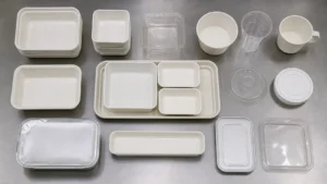 Empty unbranded airline meal packaging components arranged on a neutral catering preparation surface