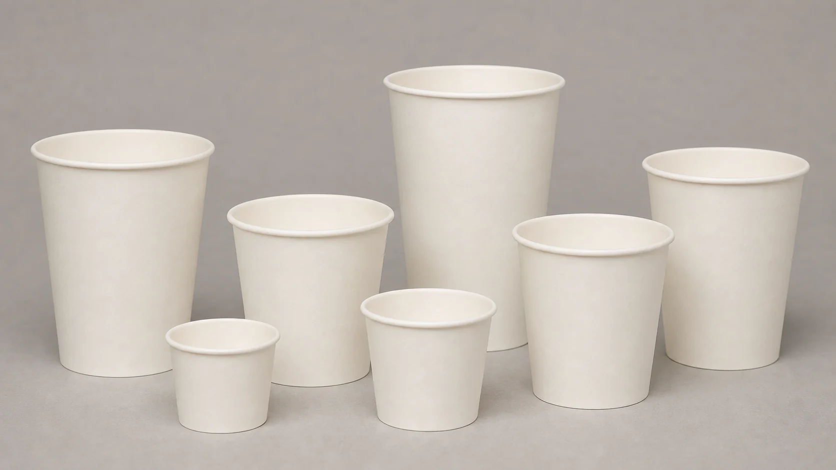 Empty unbranded paper takeaway cups arranged for artwork template review