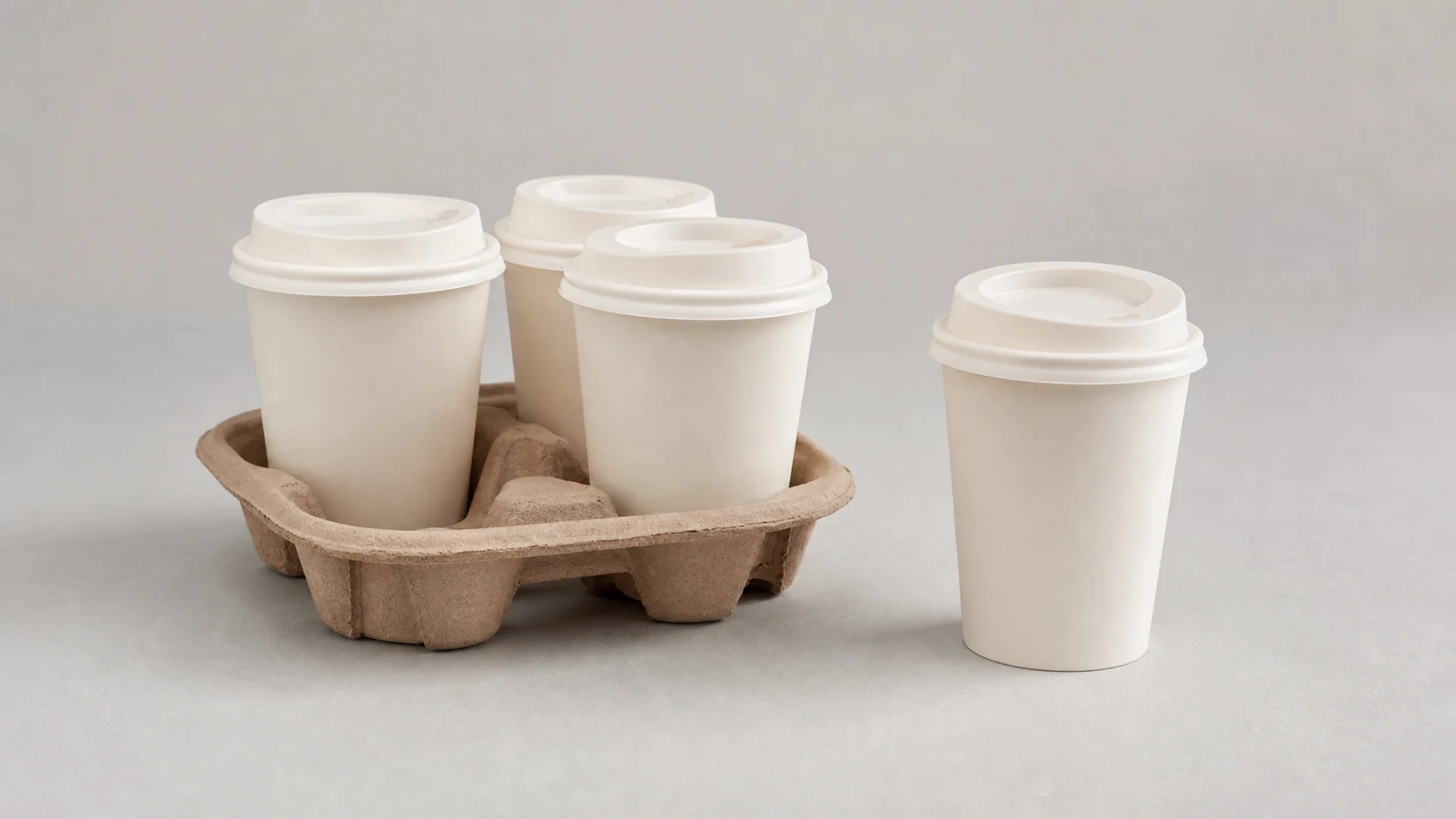 Empty unbranded paper cups with plain matching lids and cardboard carrier