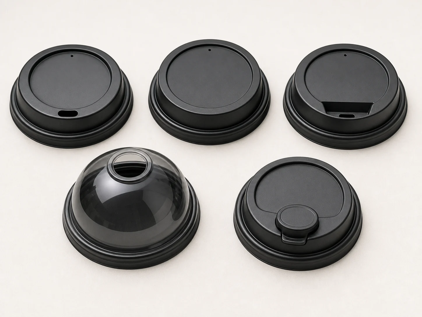 Sip-through flat straw-slot dome and closable coffee cup lid formats compared