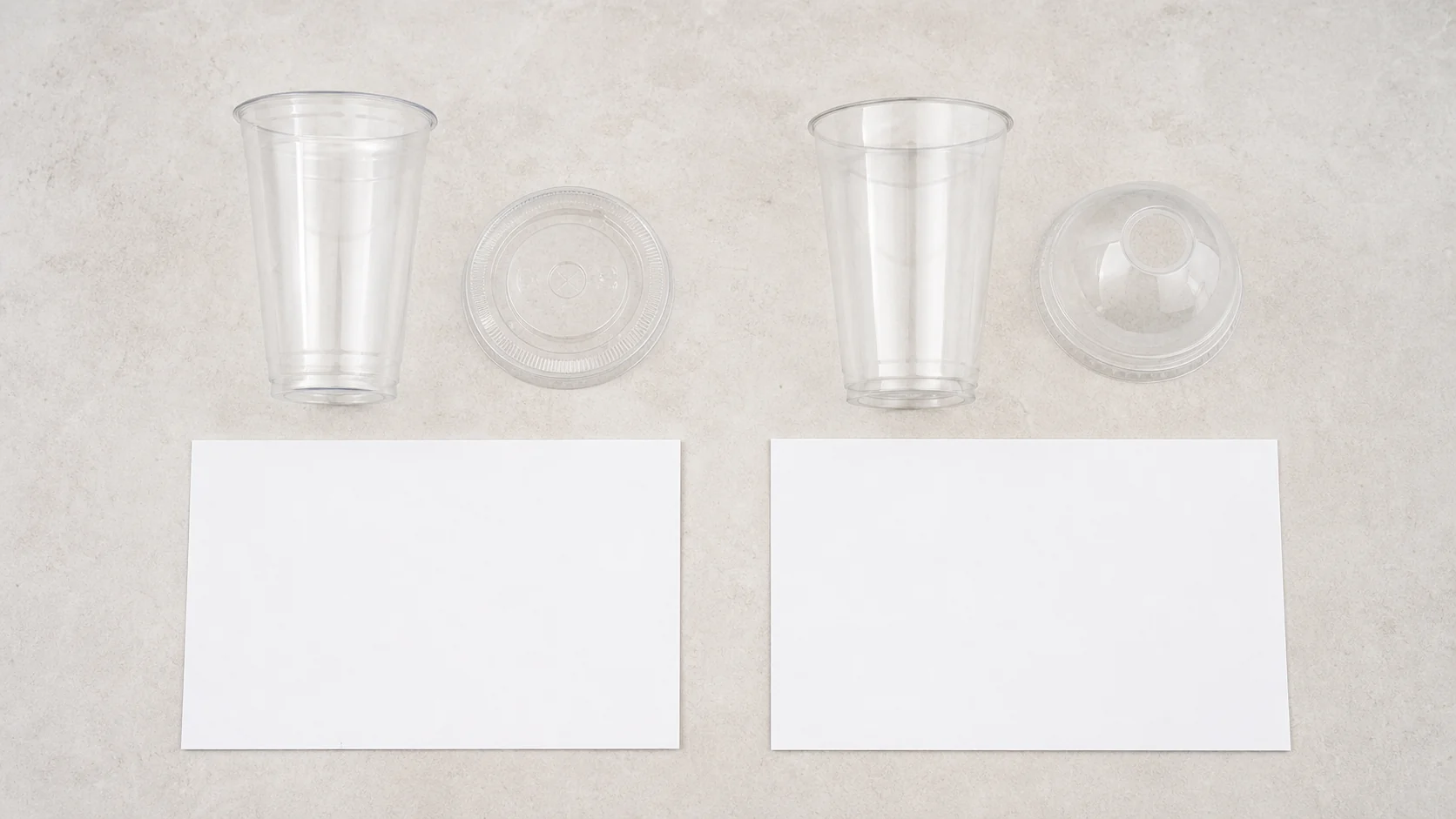 Clear PLA and PET cold drink cup samples beside blank specification cards