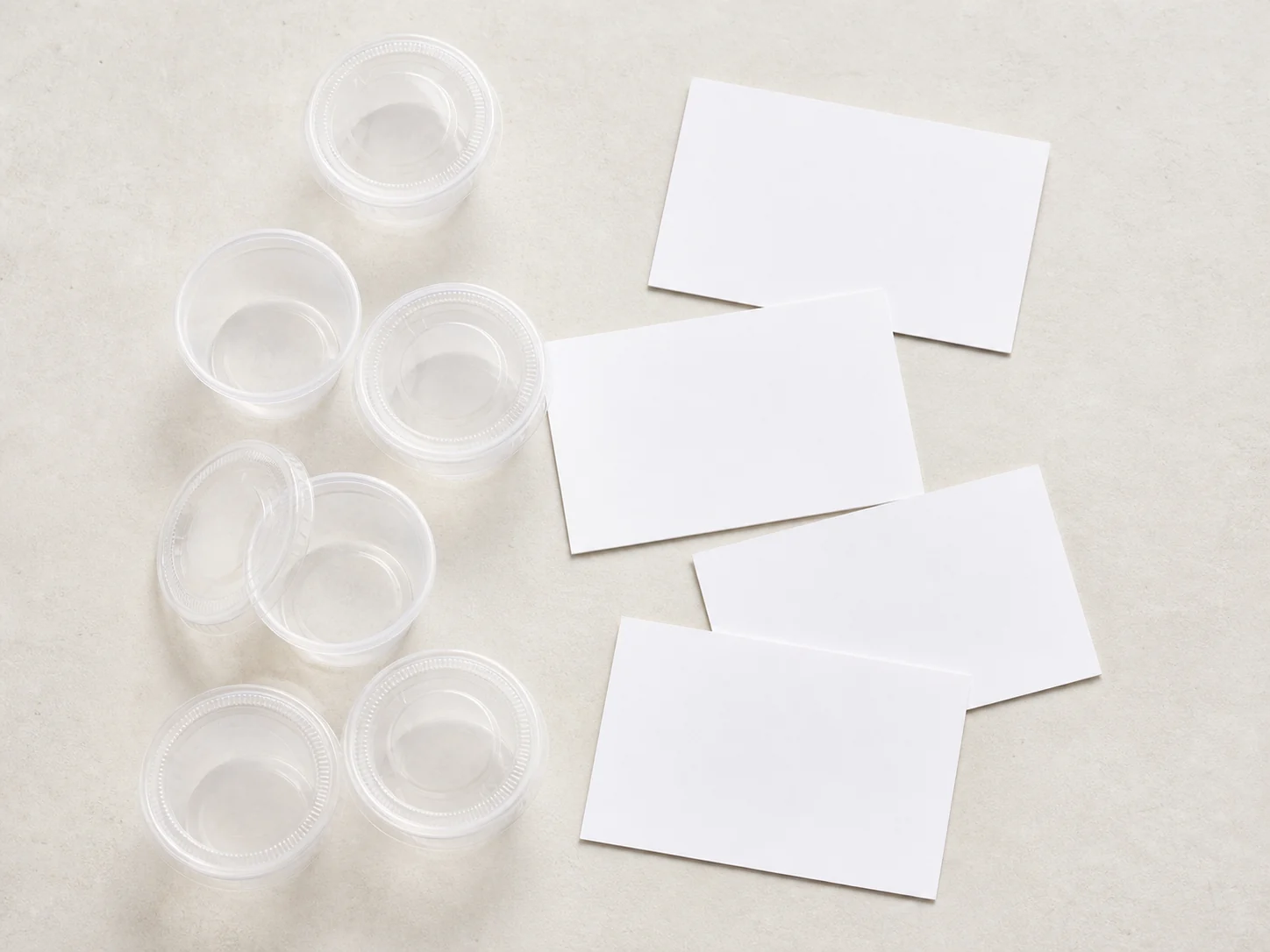 Empty condiment cup samples beside blank menu cards
